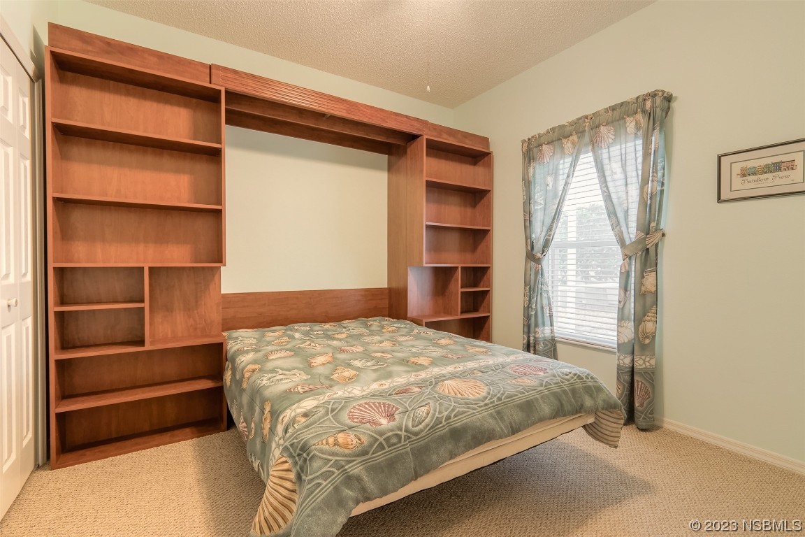 313 Mariners Gate Drive Edgewater, FL 32141 - Photo 7 of 55 a bedroom with a bed and a window