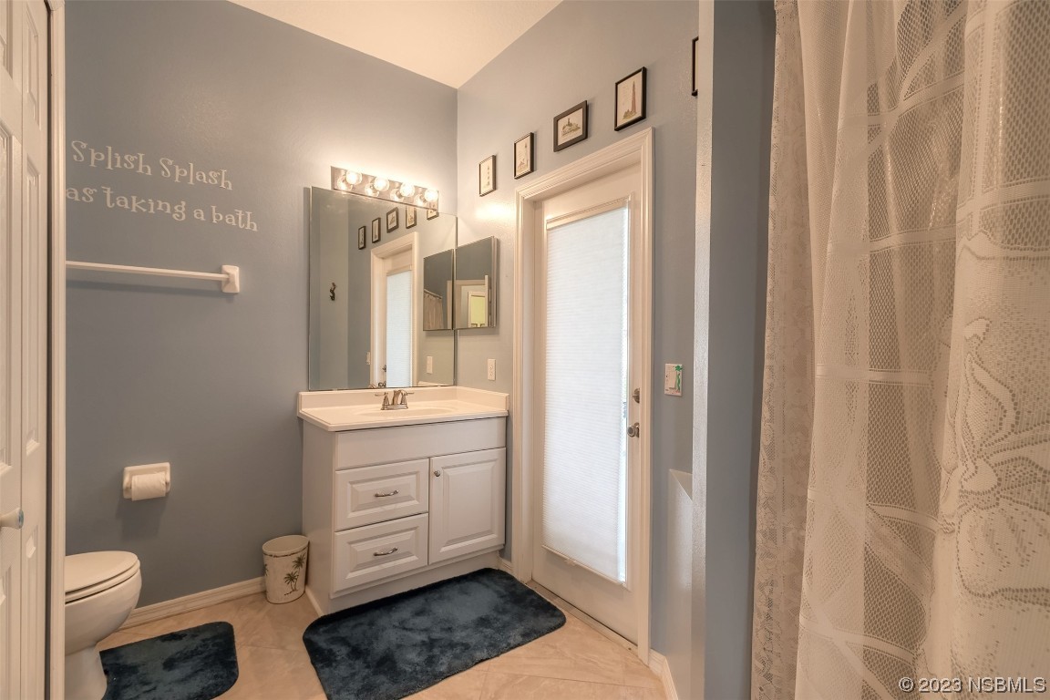 313 Mariners Gate Drive Edgewater, FL 32141 - Photo 9 of 55 a spacious bathroom with a granite countertop sink a toilet a mirror and shower