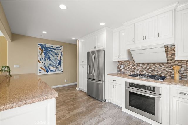 a living room with a window and wooden floor