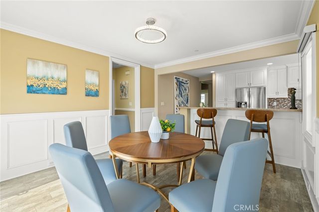 a dining room with furniture and wooden floor