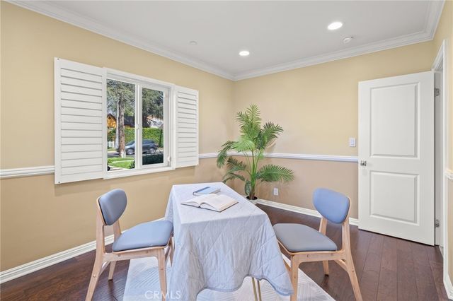 a bedroom with a large bed couch and a potted plant