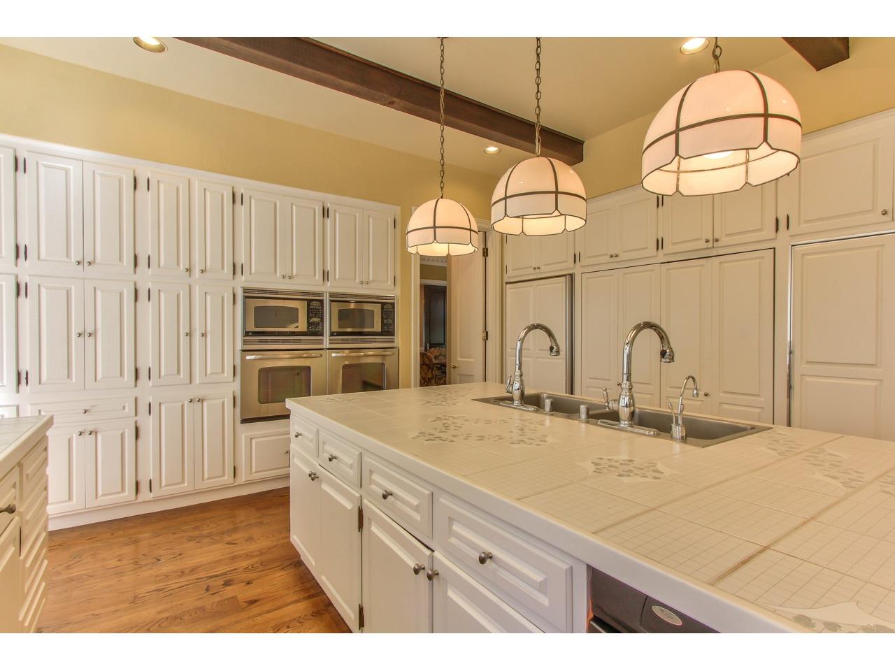 3140 Spruance Road Pebble Beach, CA 93953 - Photo 20 of 70 a kitchen with cabinets and wooden floor