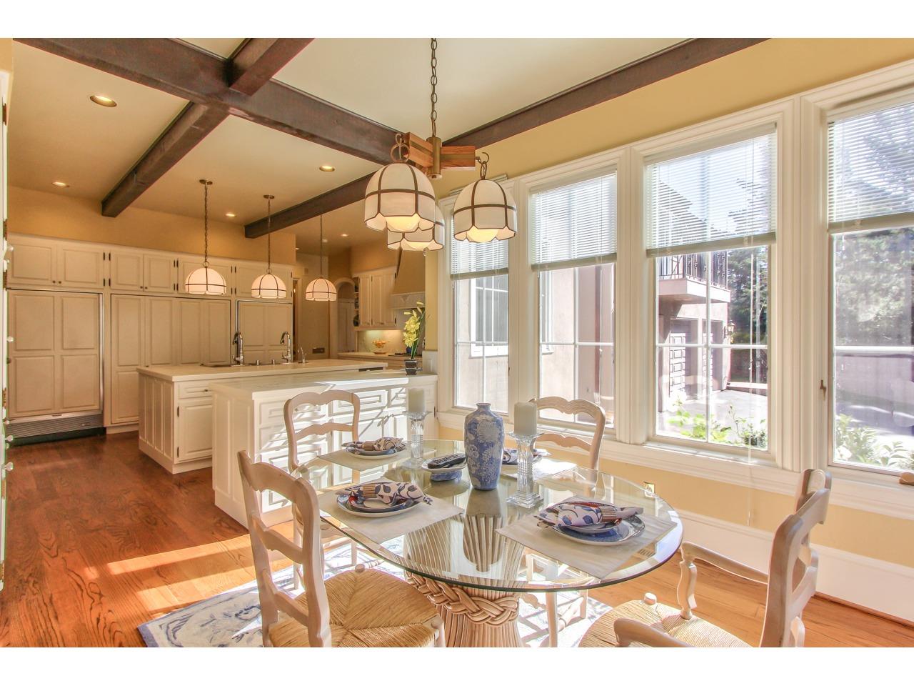3140 Spruance Road Pebble Beach, CA 93953 - Photo 23 of 70 a dining room with furniture a floor to ceiling window and potted plants