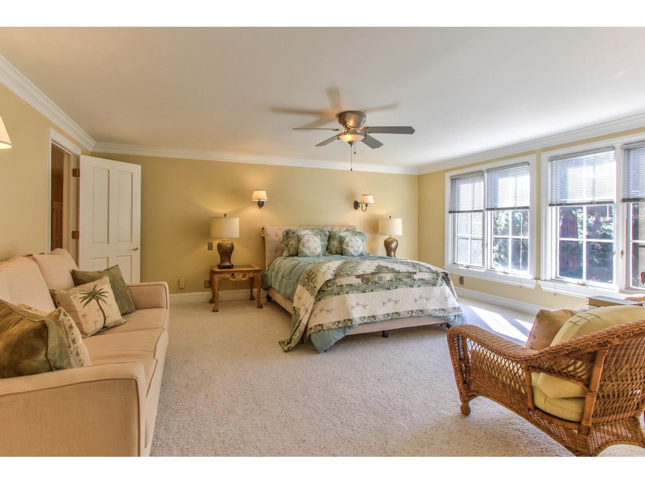 3140 Spruance Road Pebble Beach, CA 93953 - Photo 46 of 70 a spacious bedroom with a bed a couch and a large window