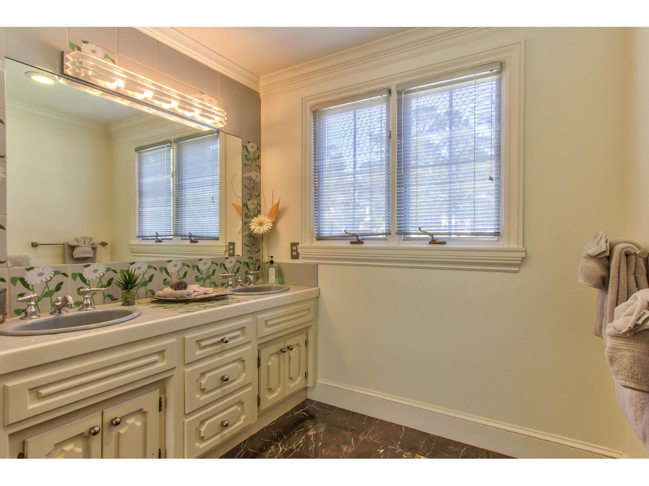 3140 Spruance Road Pebble Beach, CA 93953 - Photo 49 of 70 a bathroom with a sink and a mirror