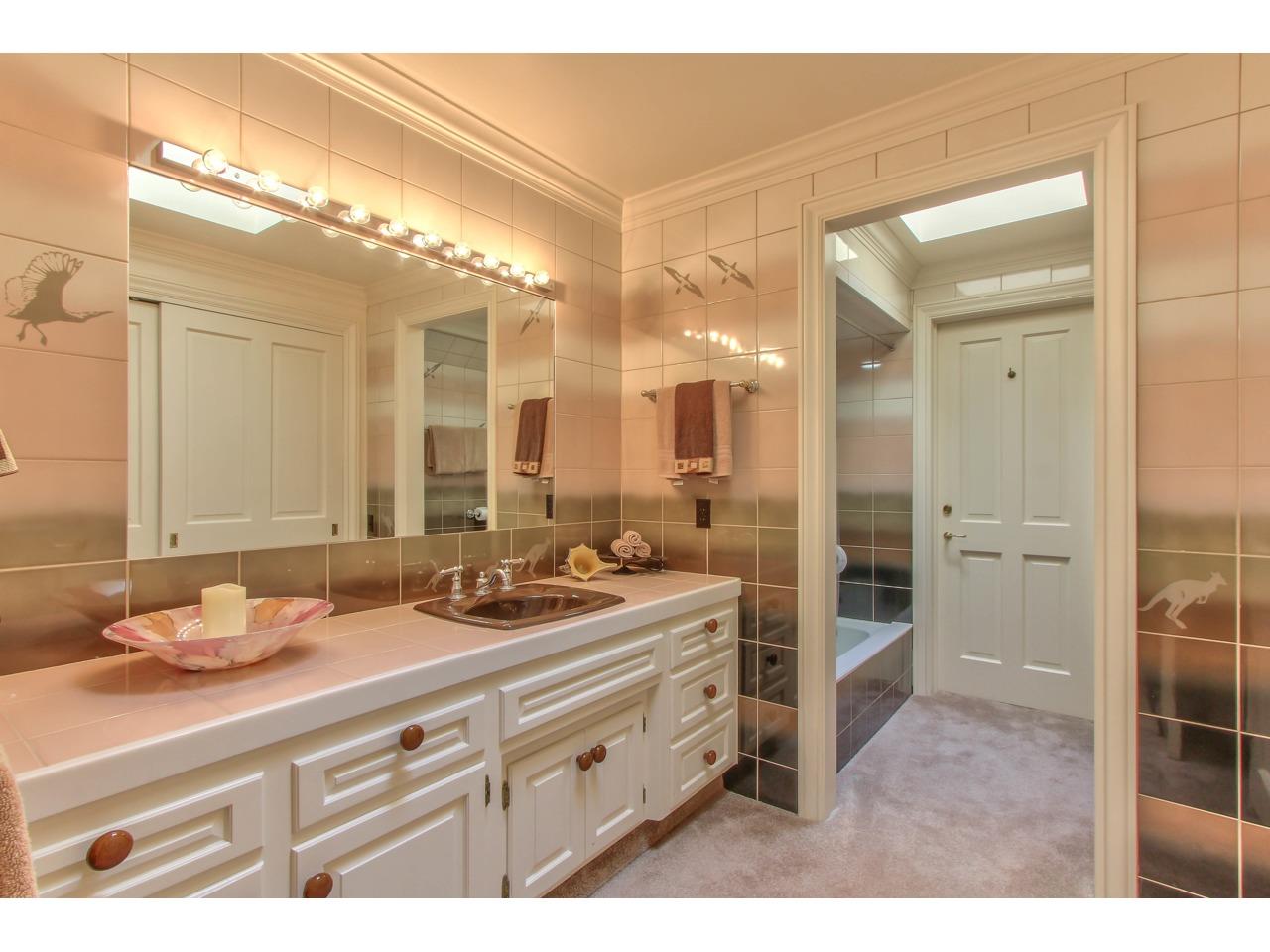 3140 Spruance Road Pebble Beach, CA 93953 - Photo 55 of 70 a bathroom with a double vanity sink and mirror