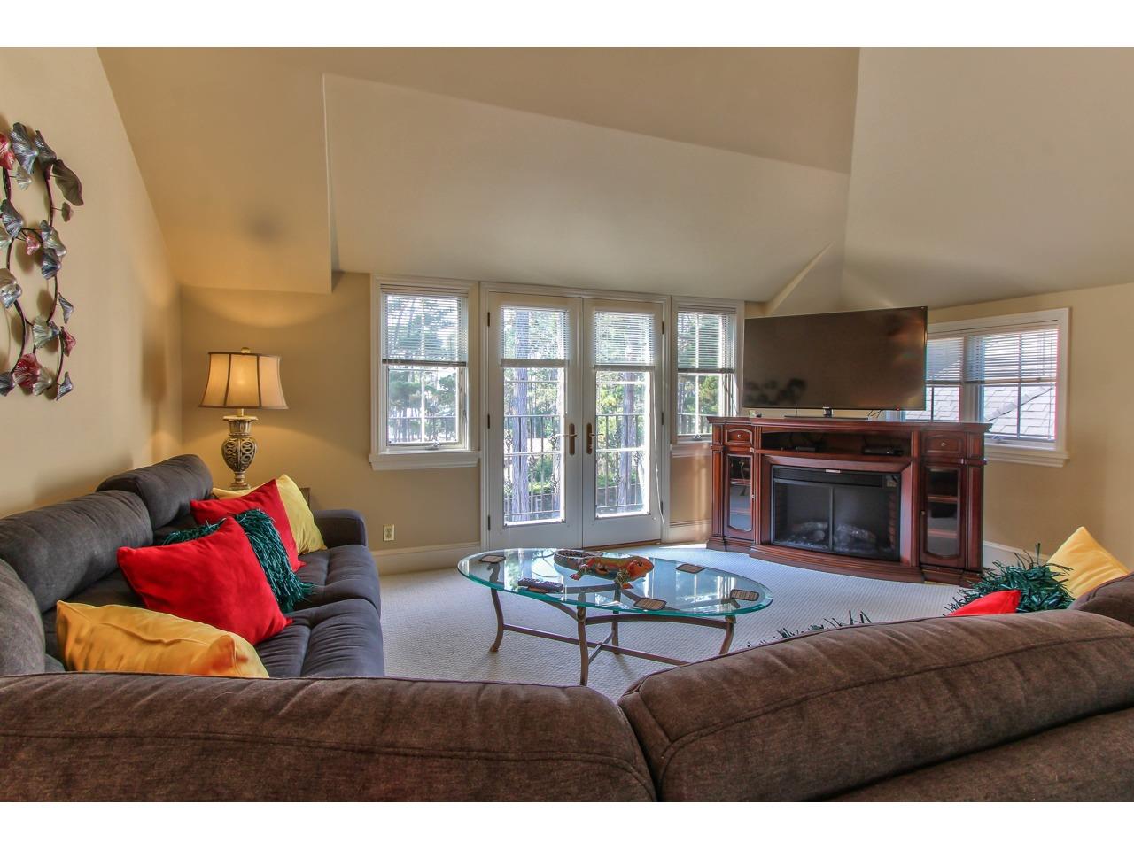 3140 Spruance Road Pebble Beach, CA 93953 - Photo 62 of 70 a living room with furniture a fireplace and a large window