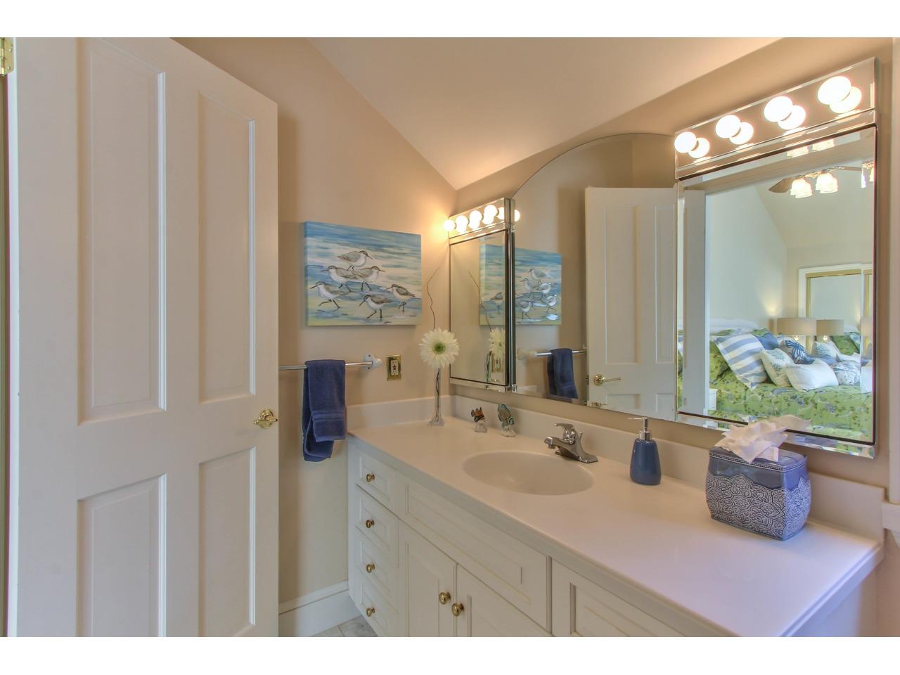3140 Spruance Road Pebble Beach, CA 93953 - Photo 64 of 70 a bathroom with a sink a vanity and a mirror