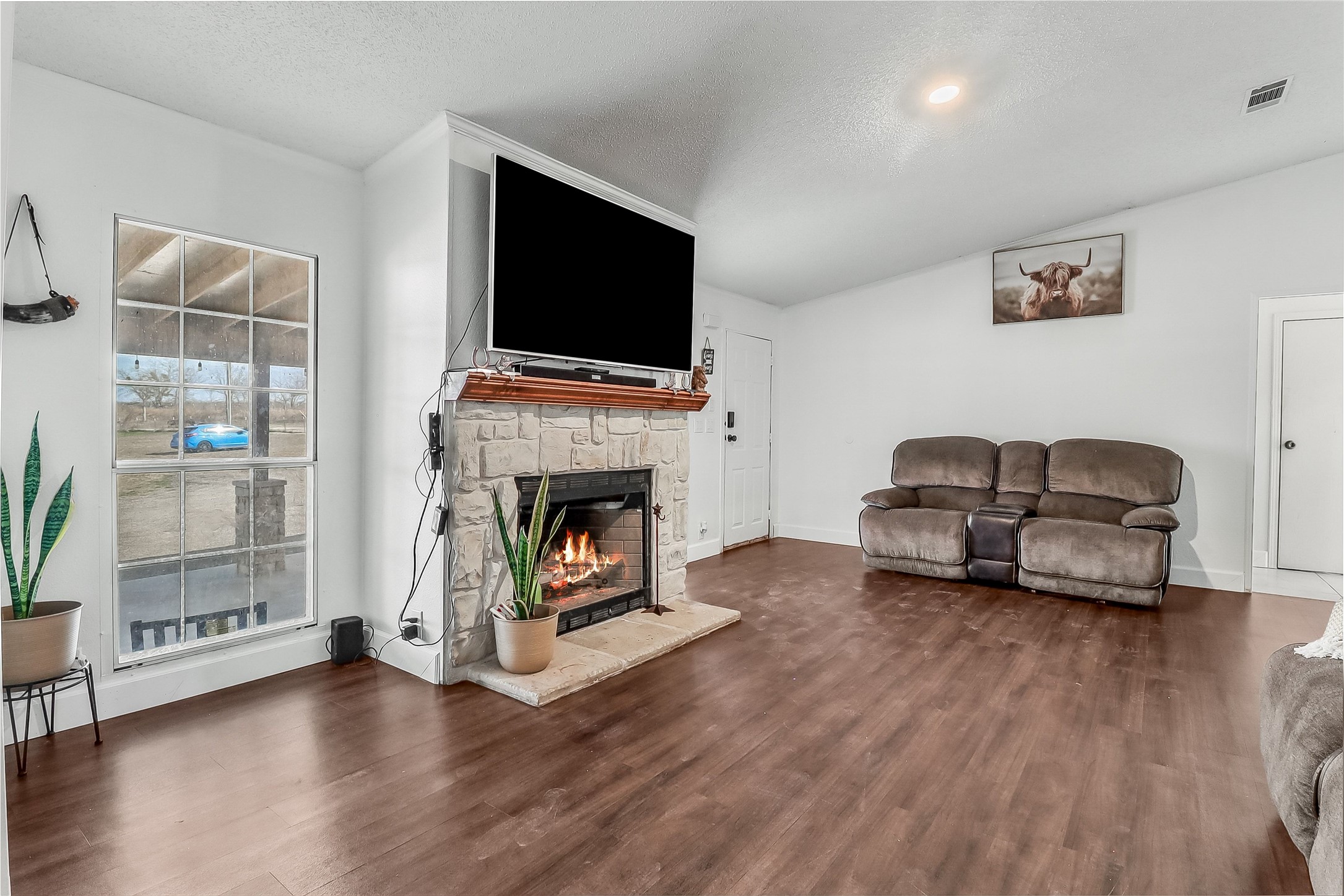 Tbd Giese Lane Elgin, TX 78621 - Photo 5 of 34 a living room with furniture a flat screen tv and a fireplace