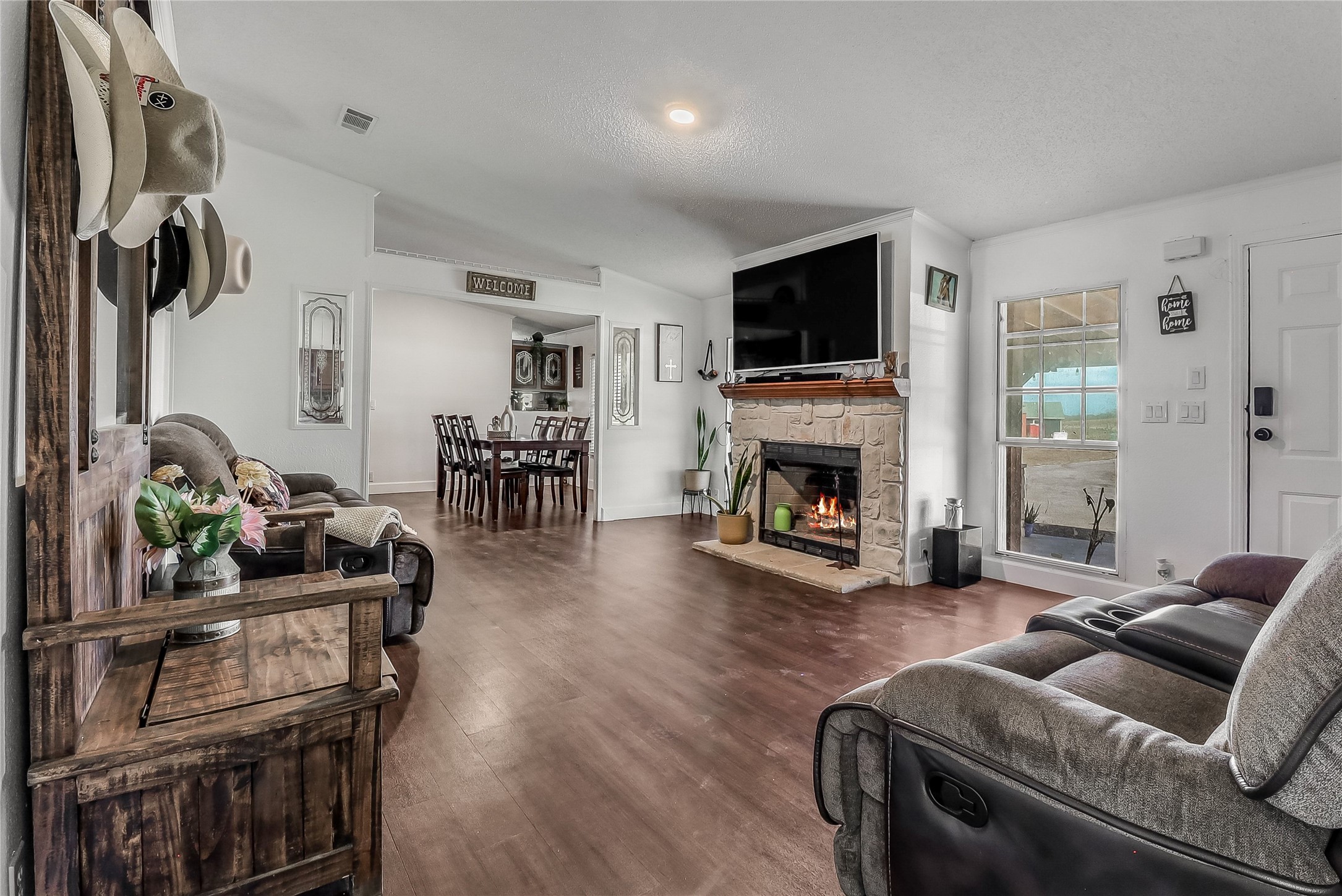 Tbd Giese Lane Elgin, TX 78621 - Photo 6 of 34 a living room with furniture a flat screen tv and a fireplace