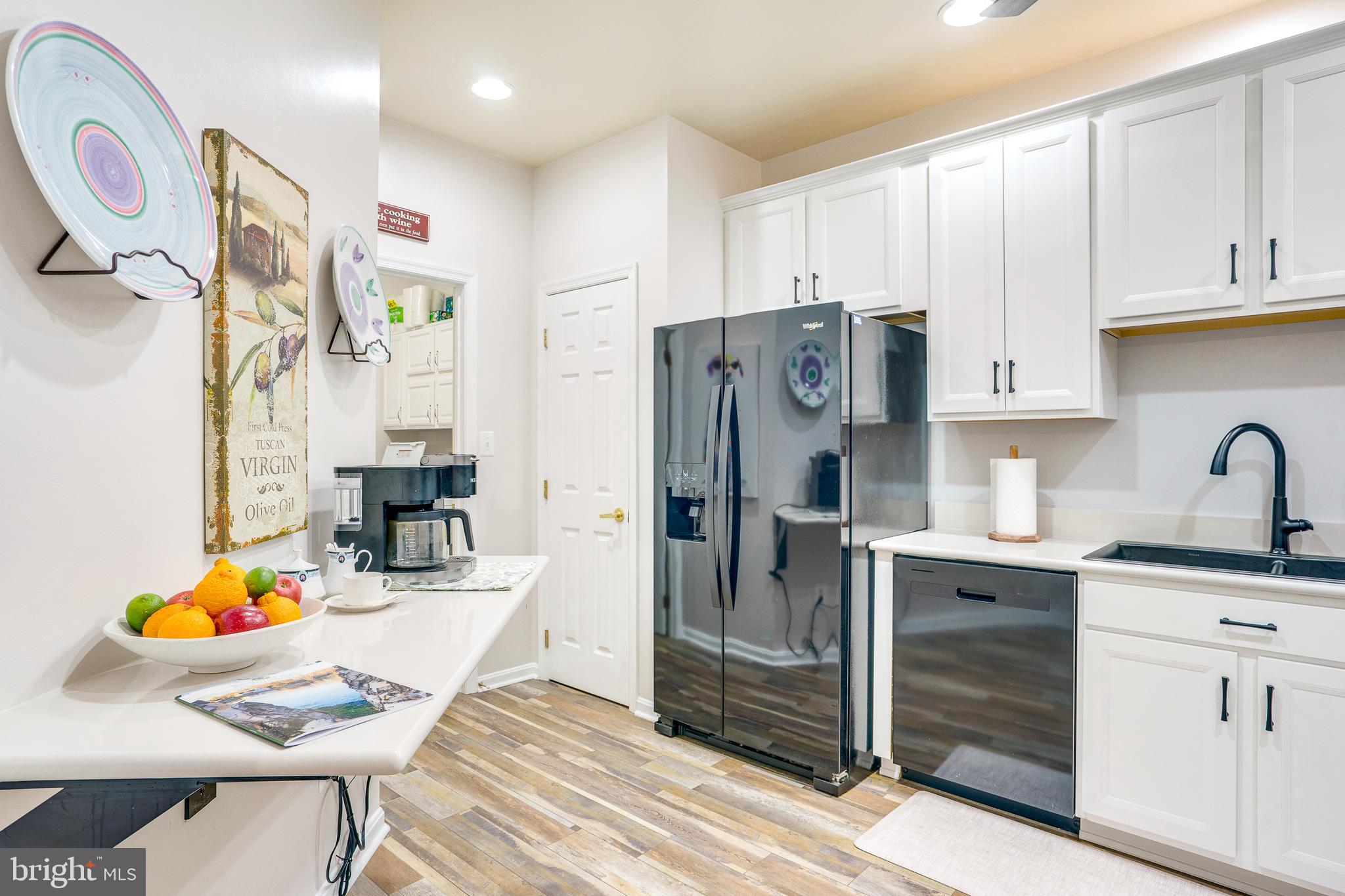 6902 Walnut Hill Drive Gainesville, VA 20155 - Photo 11 of 41 a kitchen with stainless steel appliances granite countertop a refrigerator sink and cabinets