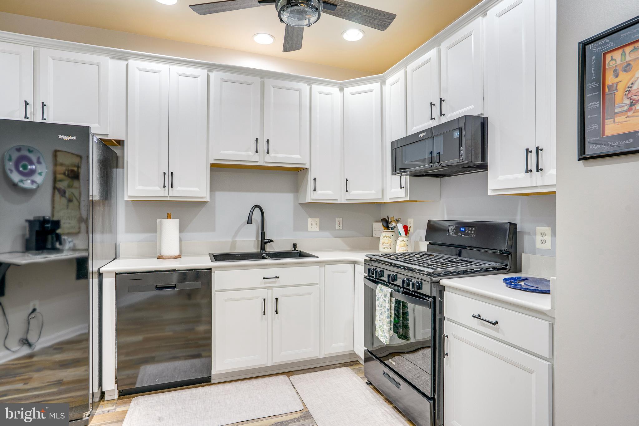6902 Walnut Hill Drive Gainesville, VA 20155 - Photo 12 of 41 a kitchen with cabinets stainless steel appliances and a counter space