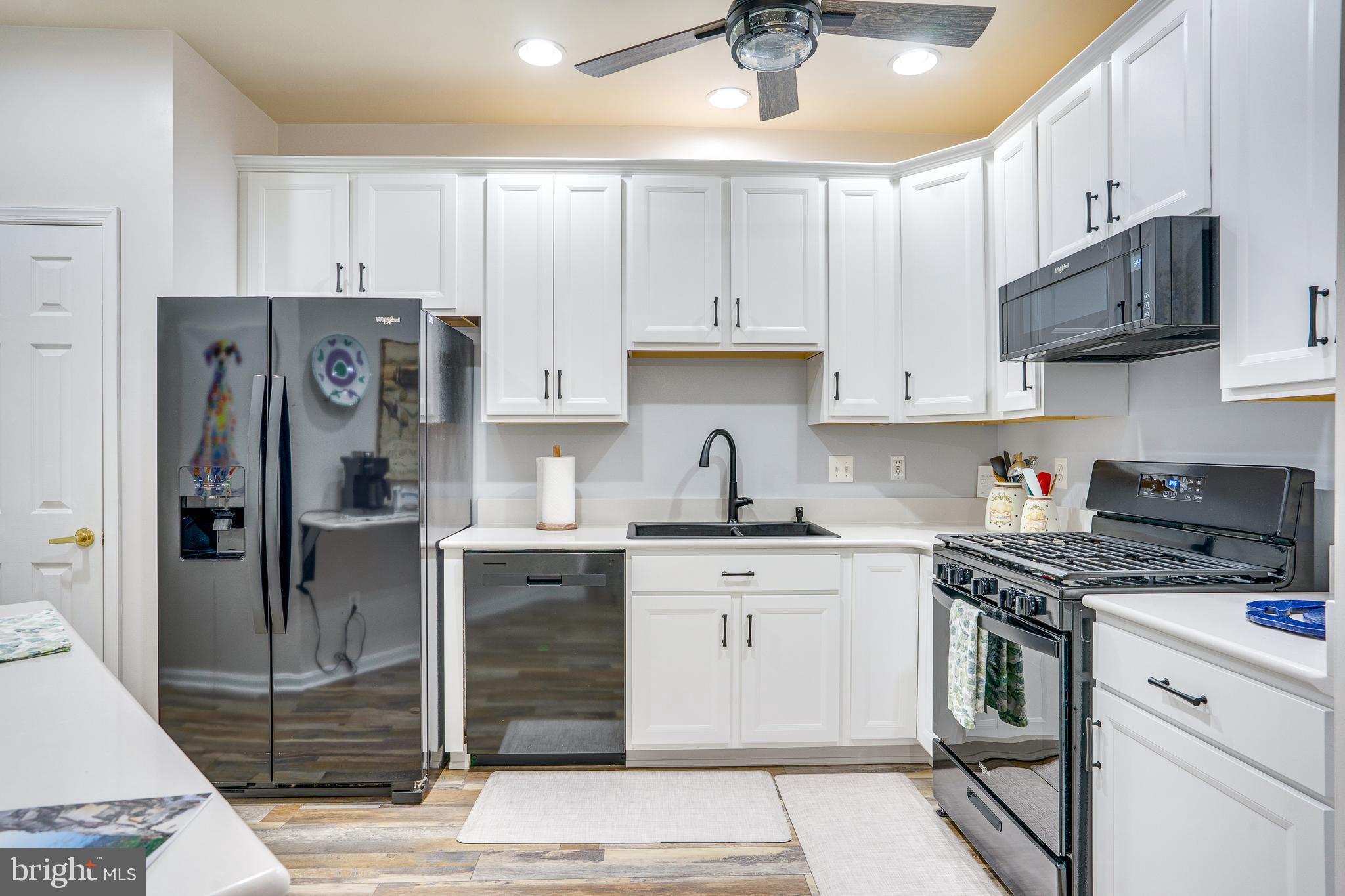 6902 Walnut Hill Drive Gainesville, VA 20155 - Photo 13 of 41 a kitchen with stainless steel appliances granite countertop a stove a refrigerator and a sink