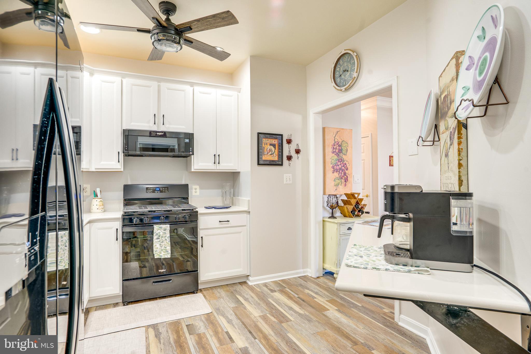 6902 Walnut Hill Drive Gainesville, VA 20155 - Photo 14 of 41 a kitchen with stainless steel appliances a stove a refrigerator and cabinets