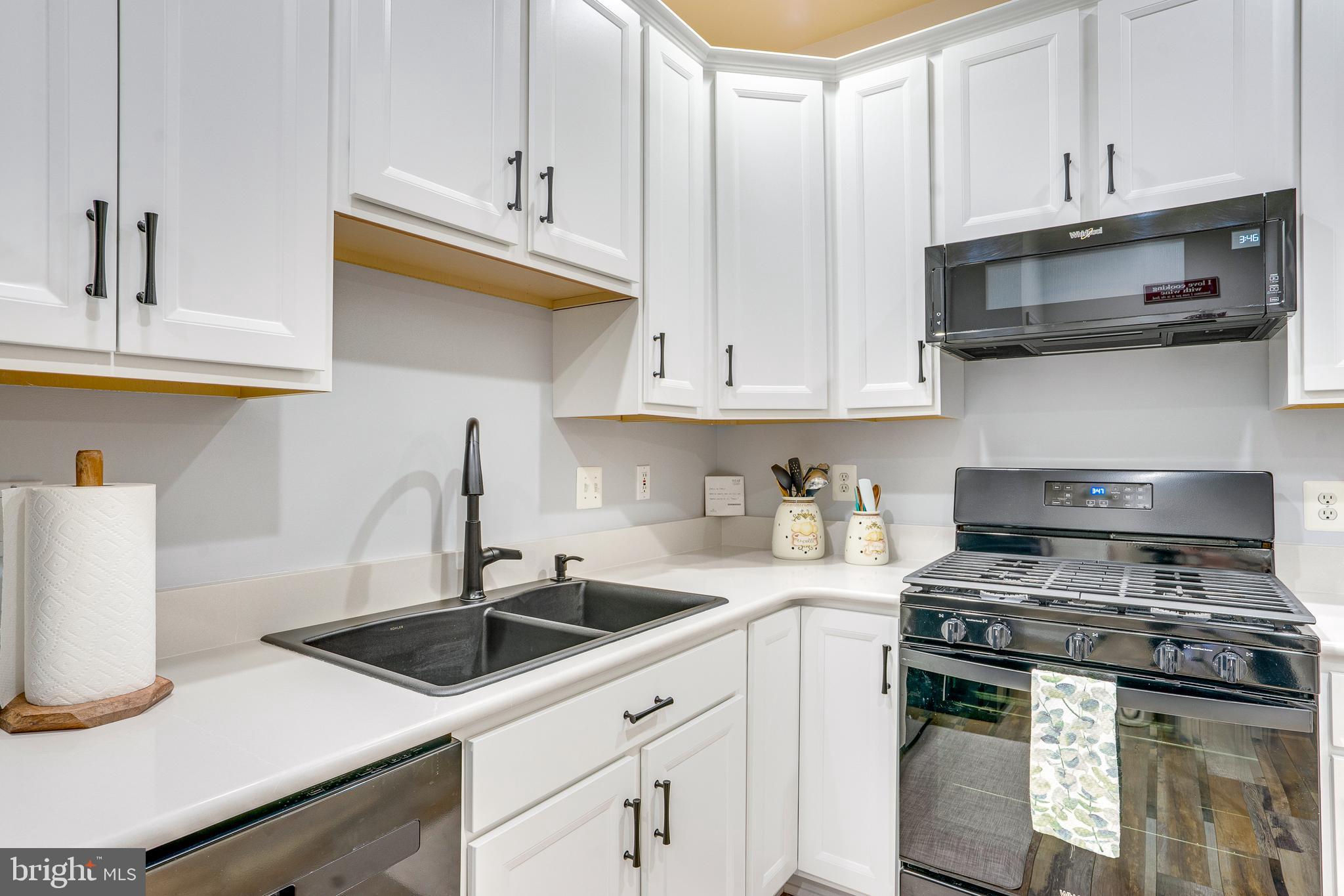 6902 Walnut Hill Drive Gainesville, VA 20155 - Photo 15 of 41 a kitchen with stainless steel appliances granite countertop a sink a stove a microwave and cabinets