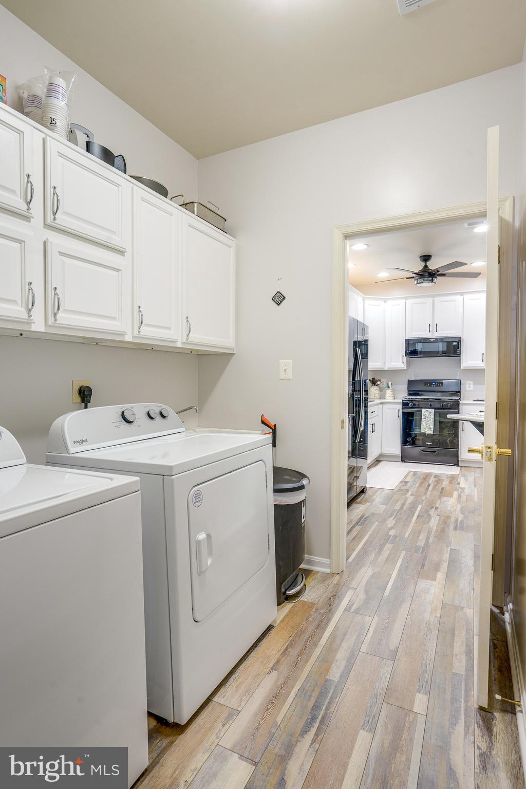 6902 Walnut Hill Drive Gainesville, VA 20155 - Photo 18 of 41 a view of washer and dryer with kitchen in the background