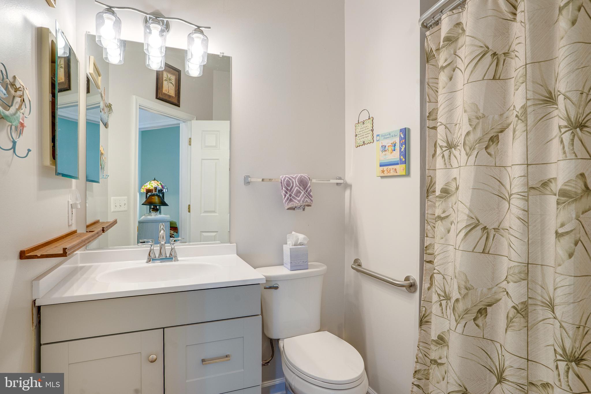 6902 Walnut Hill Drive Gainesville, VA 20155 - Photo 19 of 41 a bathroom with a sink mirror vanity and toilet