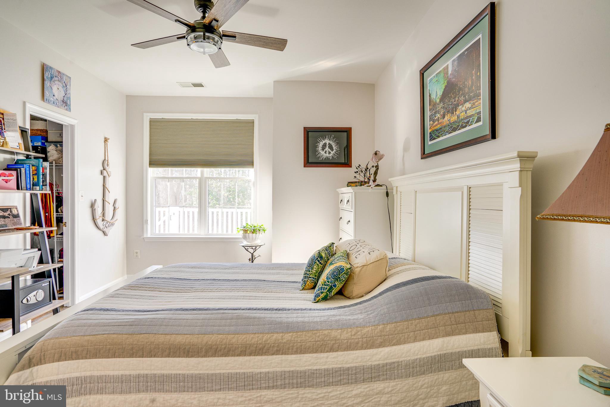 6902 Walnut Hill Drive Gainesville, VA 20155 - Photo 21 of 41 a view of a bedroom with a large bed and a window