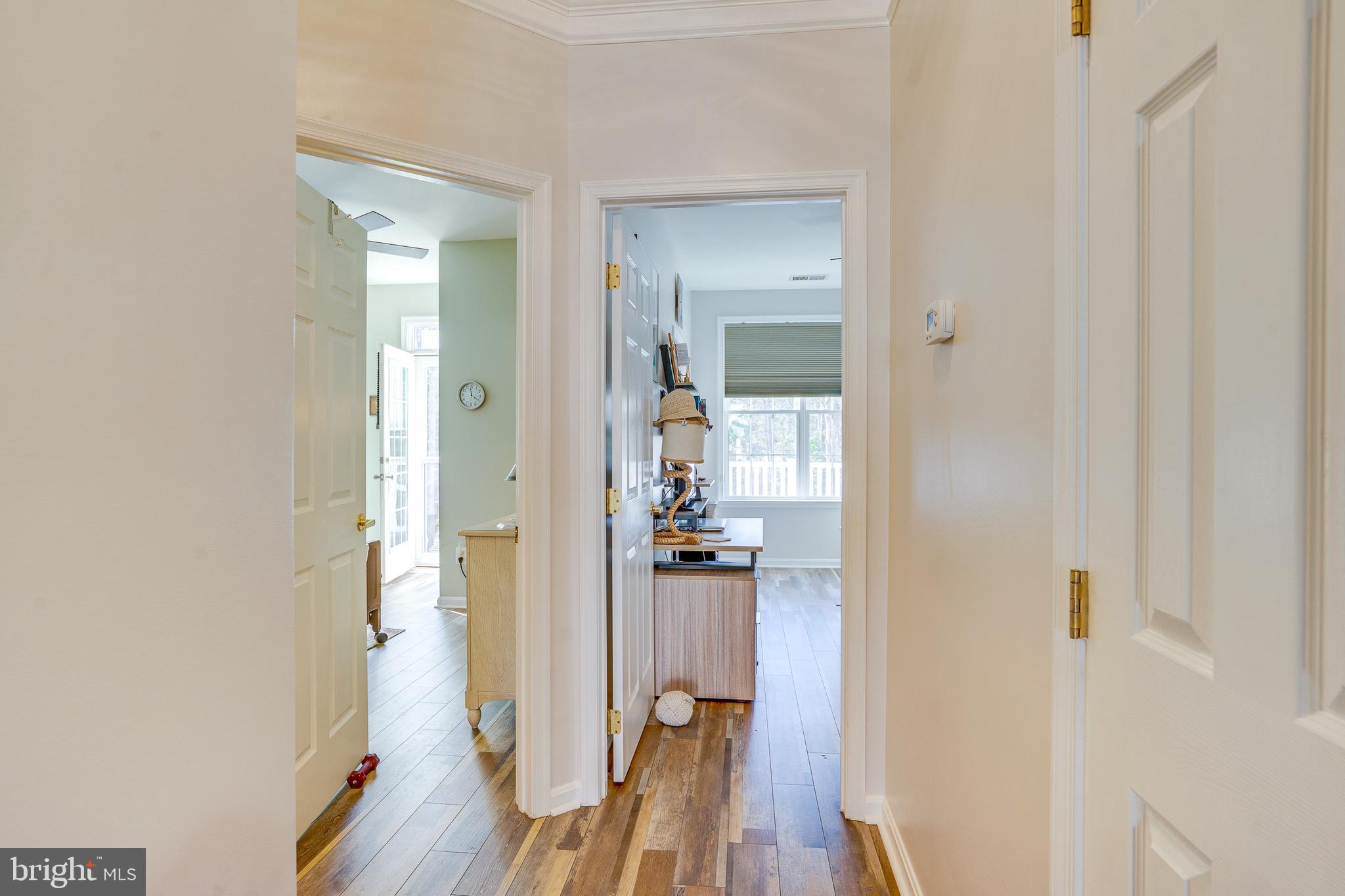 6902 Walnut Hill Drive Gainesville, VA 20155 - Photo 25 of 41 a view of a hallway with wooden floor and a bathroom
