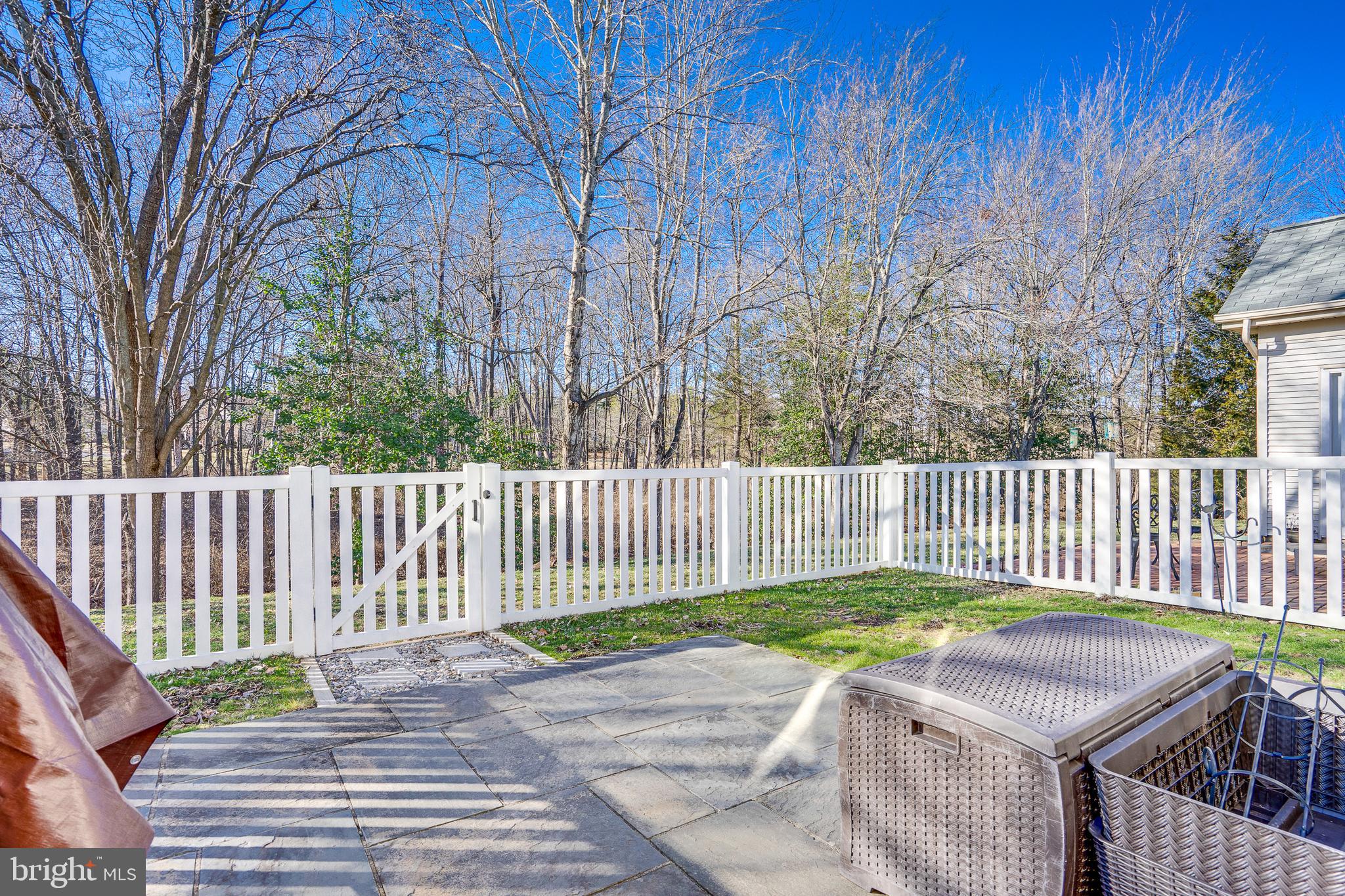 6902 Walnut Hill Drive Gainesville, VA 20155 - Photo 27 of 41 a white house with a small yard and wooden fence