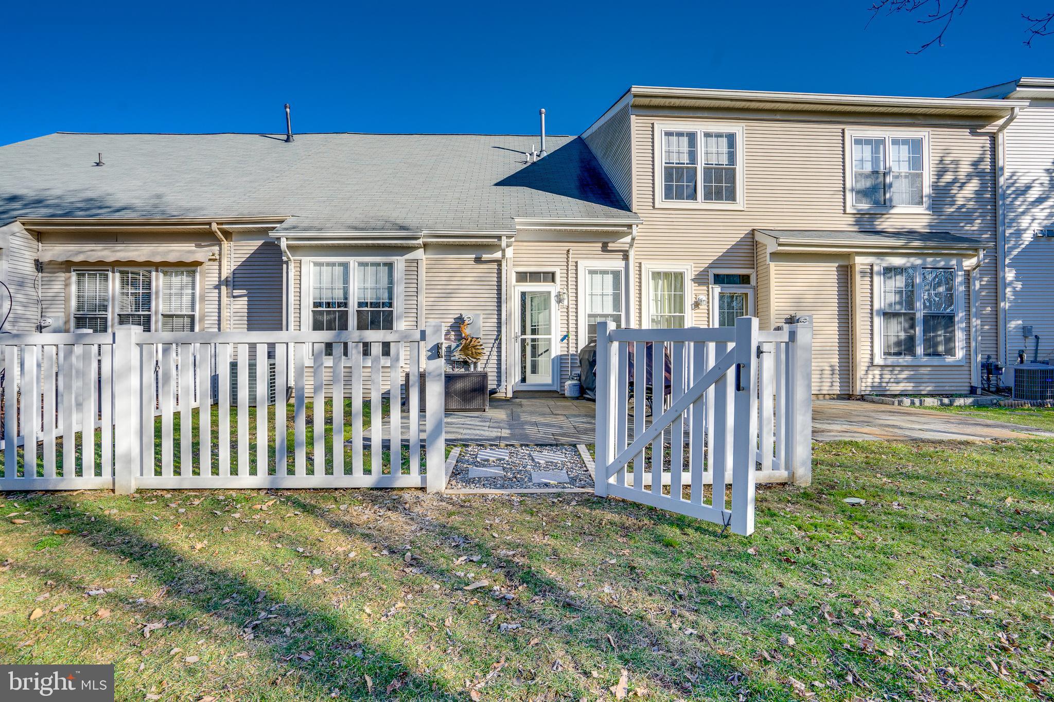 6902 Walnut Hill Drive Gainesville, VA 20155 - Photo 31 of 41 a view of a house with wooden fence and a porch