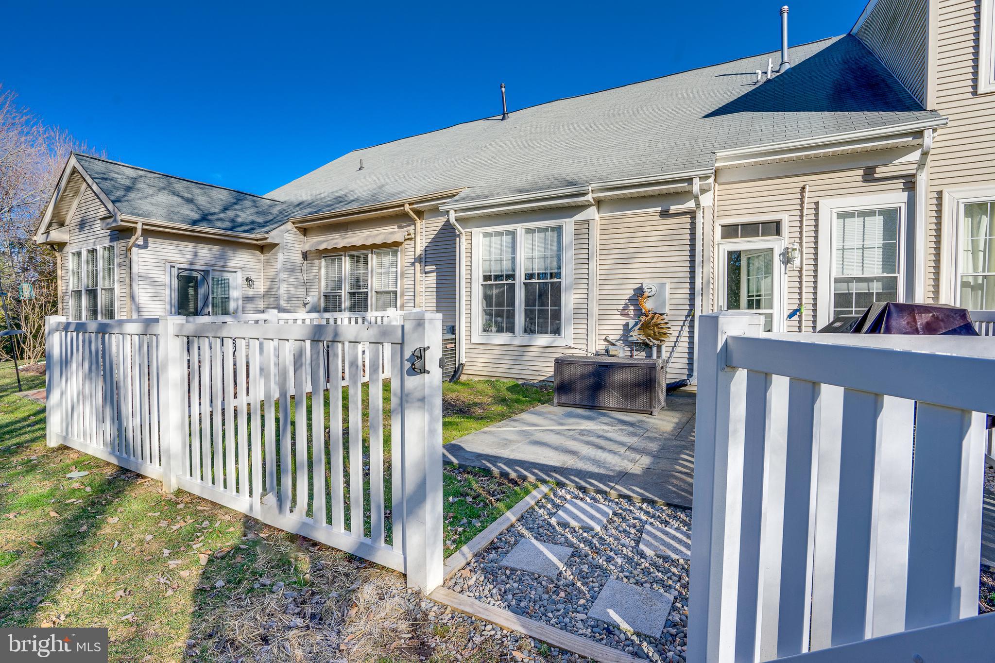 6902 Walnut Hill Drive Gainesville, VA 20155 - Photo 32 of 41 a view of a house with wooden fence next to a yard