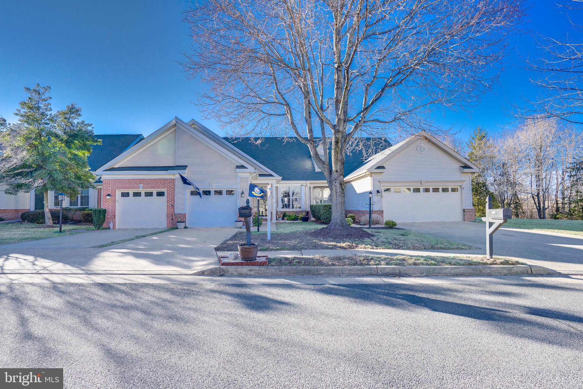 6902 Walnut Hill Drive Gainesville, VA 20155 - Photo 39 of 41 a view of a house with a yard and garage