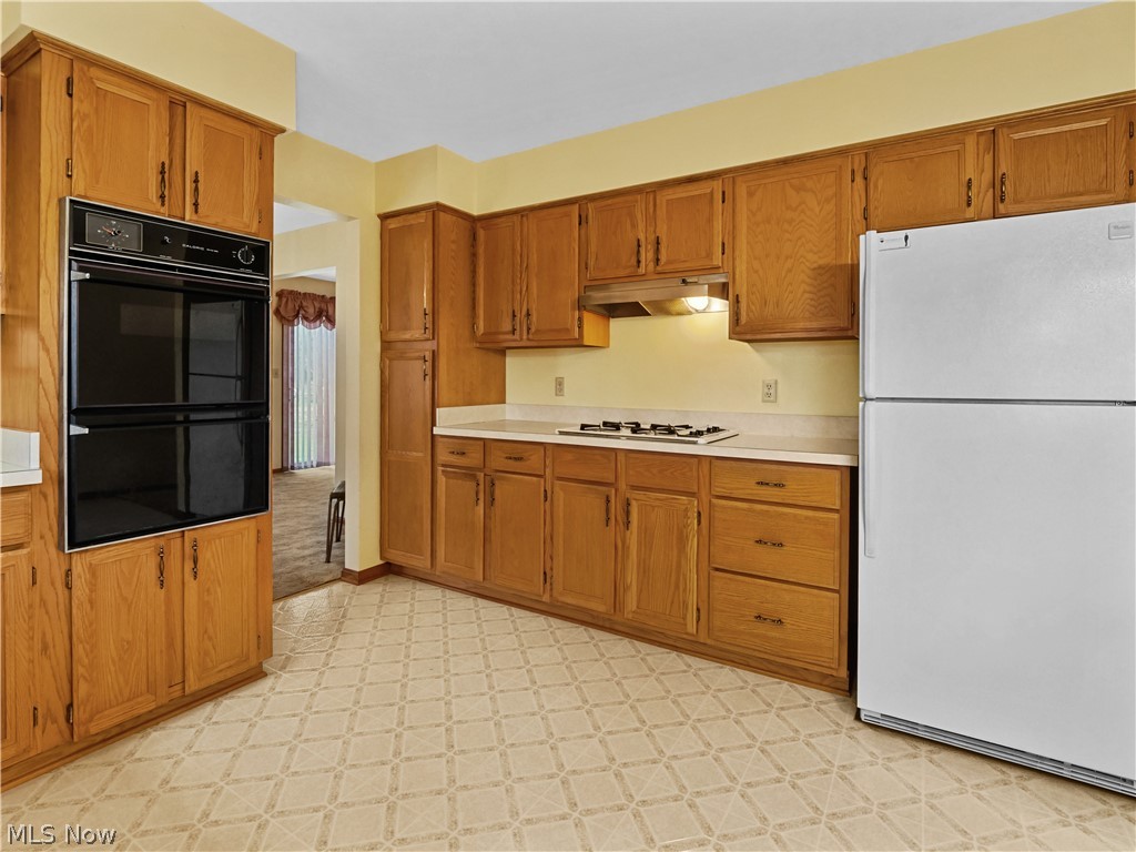 5175 Case Road North Ridgeville, OH 44039 - Photo 11 of 28 Kitchen with white appliances and light tile floors