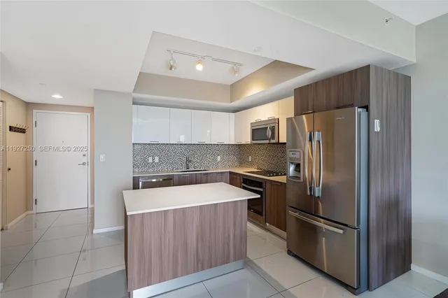a kitchen with a refrigerator and a sink