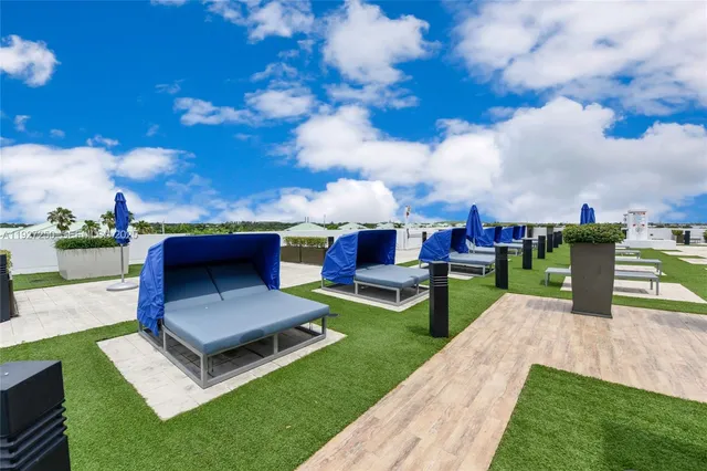 a view of a house with backyard sitting area and garden