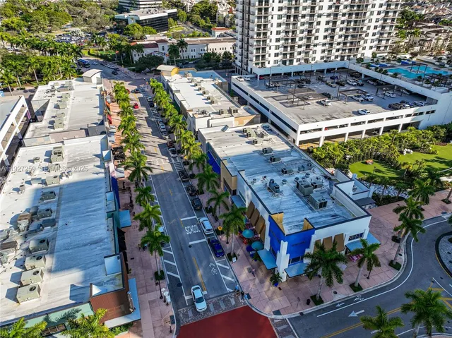 an aerial view of multiple houses with yard