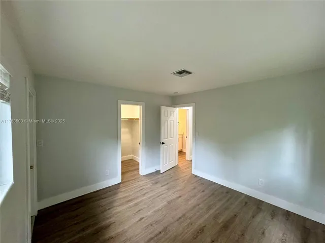 a view of an empty room and wooden floor