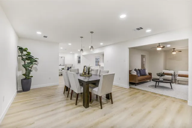a view of a dining room with furniture and wooden floor