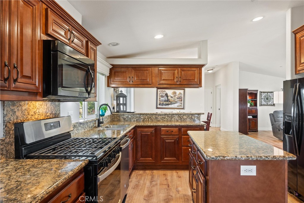 19350 Timbercove Drive Corning, CA 96021 - Photo 13 of 60 a kitchen with stainless steel appliances granite countertop a stove top oven a sink and dishwasher
