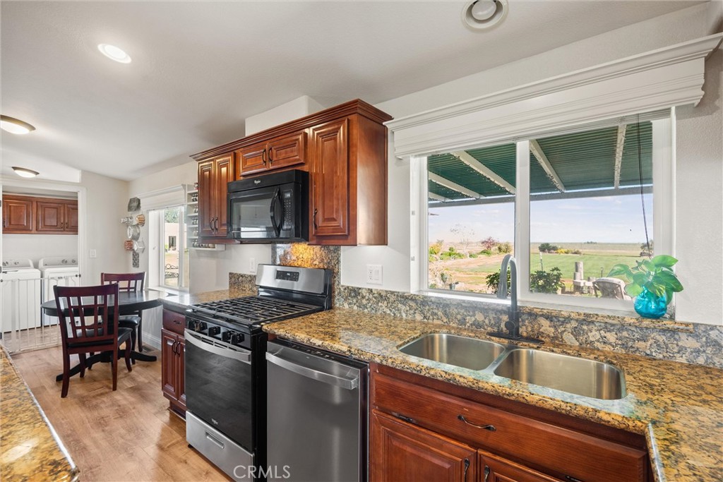 19350 Timbercove Drive Corning, CA 96021 - Photo 18 of 60 a kitchen with a stove a sink and a microwave