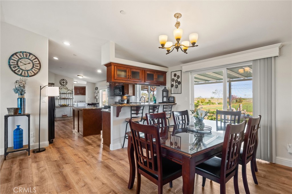 19350 Timbercove Drive Corning, CA 96021 - Photo 21 of 60 a view of a dining room with furniture a chandelier and wooden floor