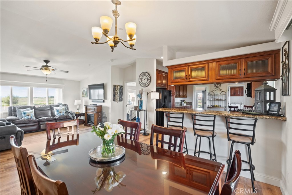 19350 Timbercove Drive Corning, CA 96021 - Photo 22 of 60 a dining room with furniture a rug and a chandelier