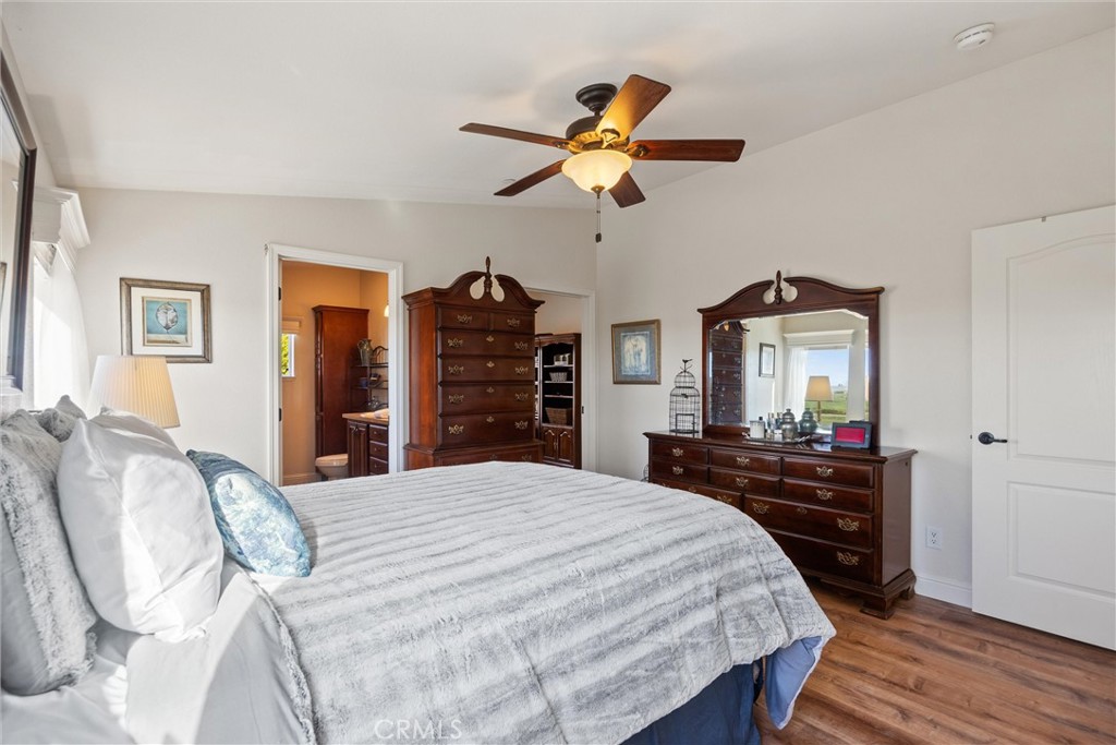 19350 Timbercove Drive Corning, CA 96021 - Photo 25 of 60 a bedroom with a bed and wooden floor