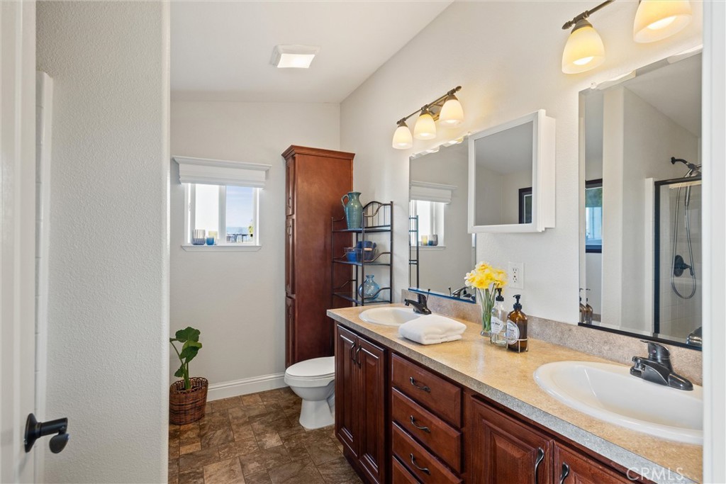 19350 Timbercove Drive Corning, CA 96021 - Photo 27 of 60 a bathroom with a granite countertop sink a toilet and shower