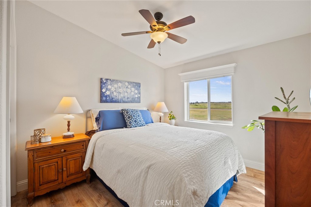 19350 Timbercove Drive Corning, CA 96021 - Photo 28 of 60 a bedroom with a bed and a chandelier