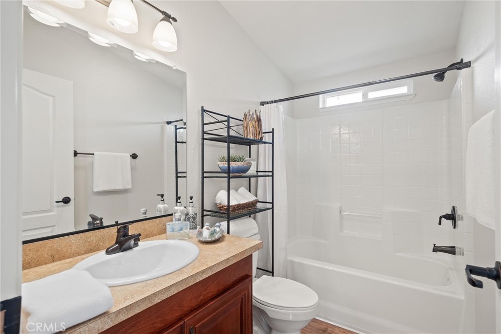 19350 Timbercove Drive Corning, CA 96021 - Photo 31 of 60 a bathroom with a granite countertop sink toilet mirror and shower