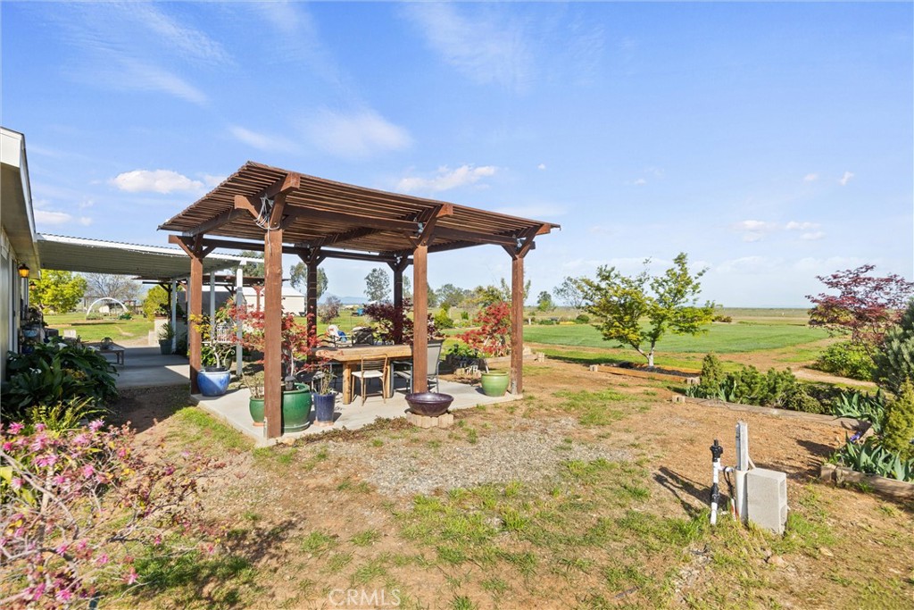 19350 Timbercove Drive Corning, CA 96021 - Photo 40 of 60 a view of a patio with a table and chairs under an umbrella