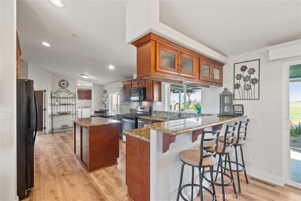 19350 Timbercove Drive Corning, CA 96021 - Photo 10 of 60 a dining room with stainless steel appliances granite countertop a stove and a dining table chair