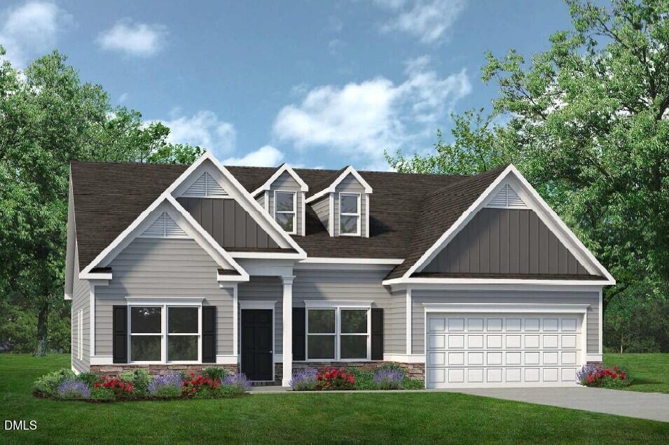 a front view of a house with a yard and garage