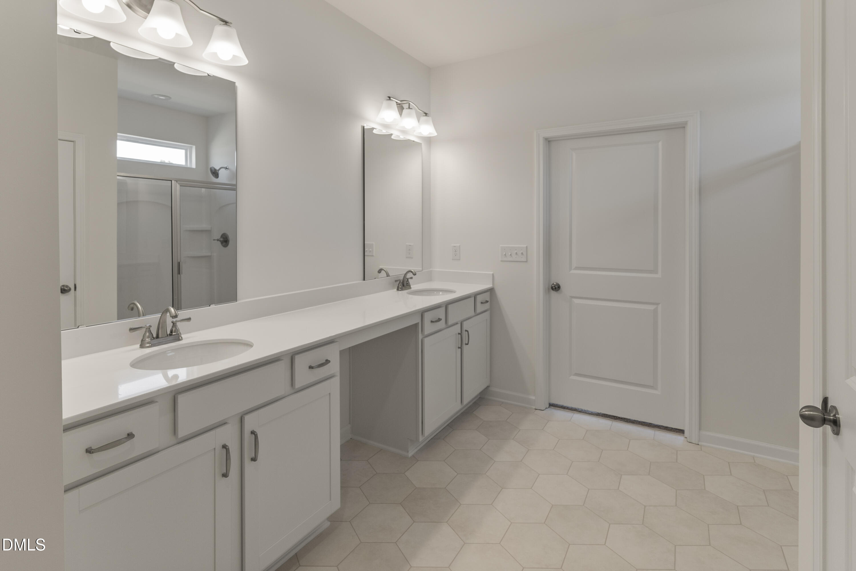 243 Spirit Spgs Road Smithfield, NC 27577 - Photo 13 of 20 a spacious bathroom with a double vanity sink a mirror and a