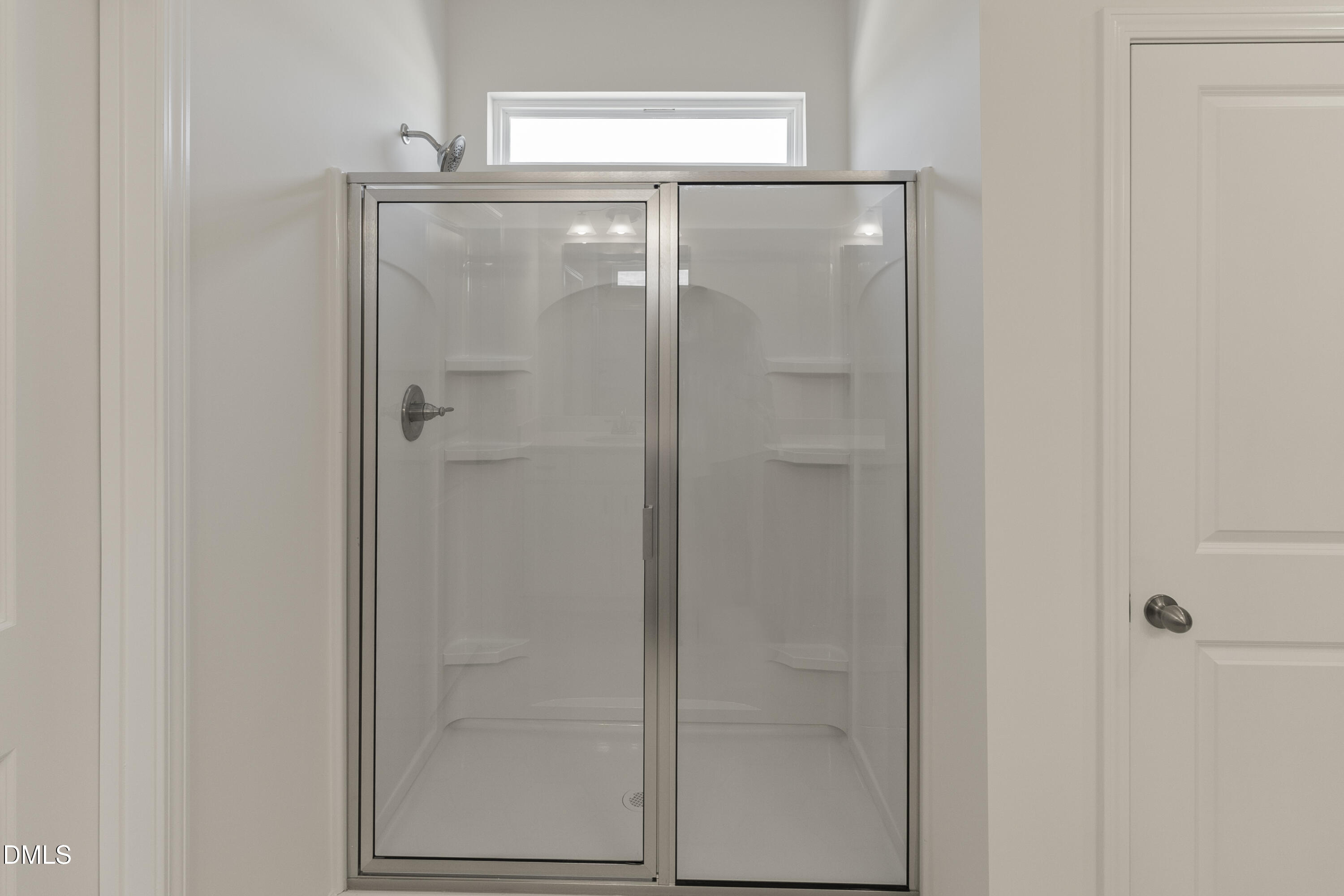 243 Spirit Spgs Road Smithfield, NC 27577 - Photo 14 of 20 a bathroom with a glass shower door