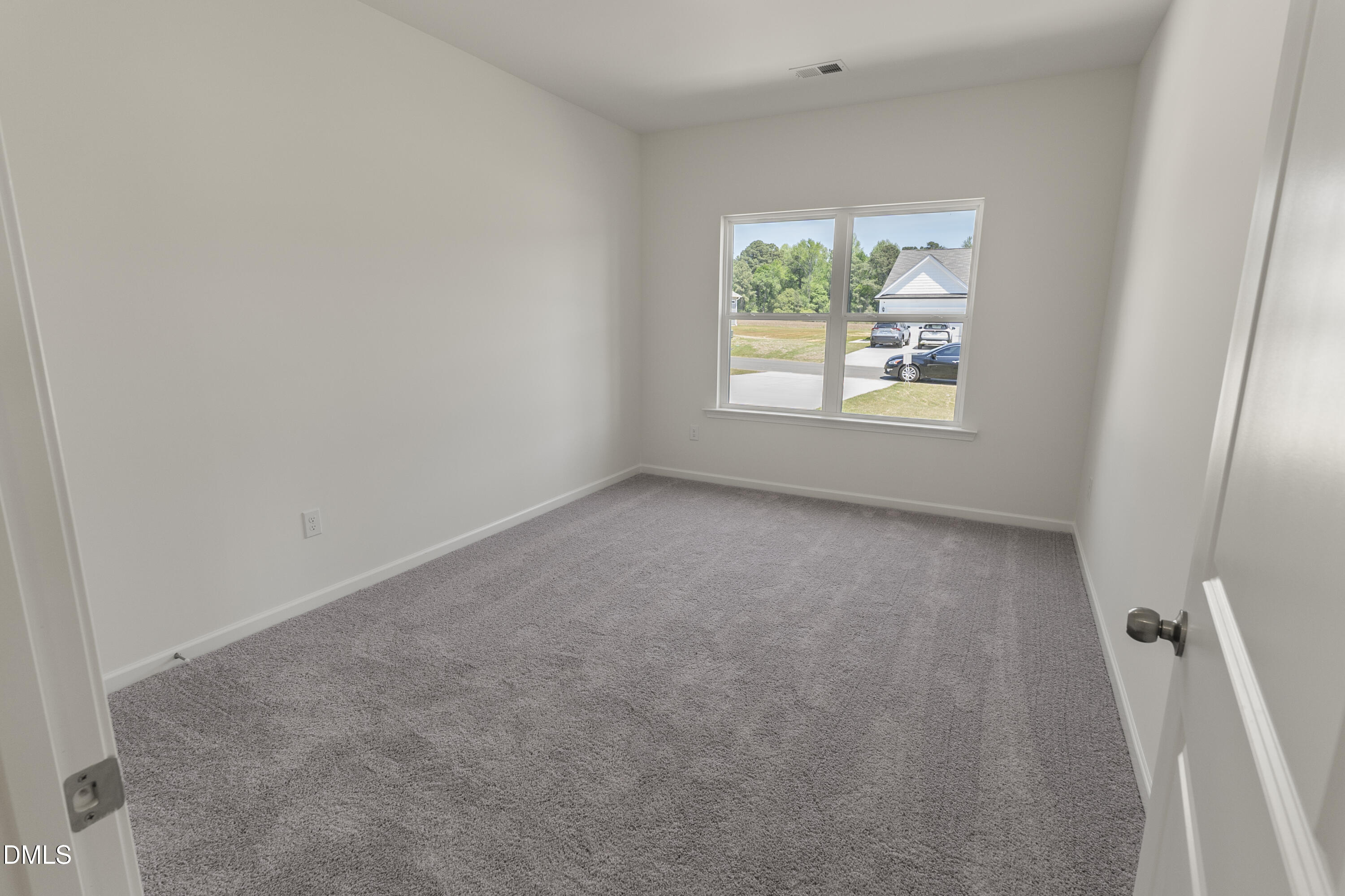 243 Spirit Spgs Road Smithfield, NC 27577 - Photo 18 of 20 an empty room with windows