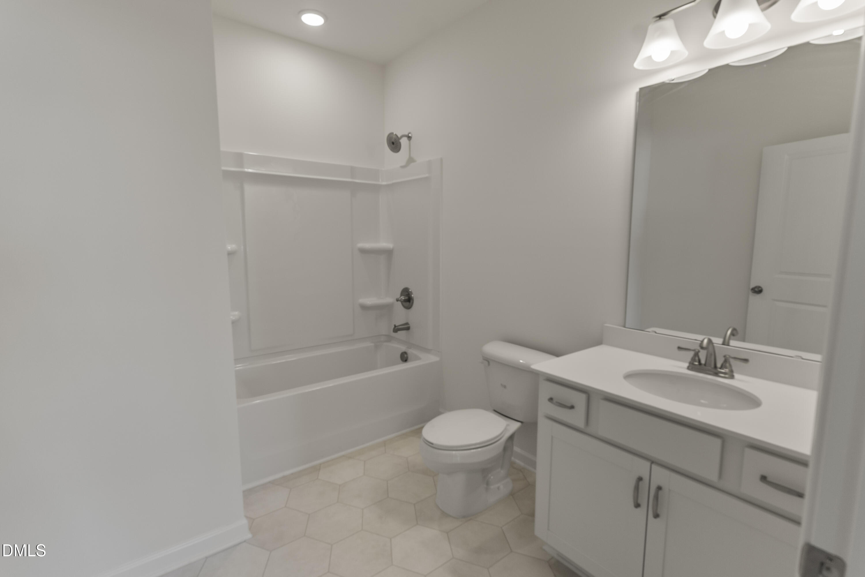 243 Spirit Spgs Road Smithfield, NC 27577 - Photo 19 of 20 a bathroom with a sink a toilet and shower