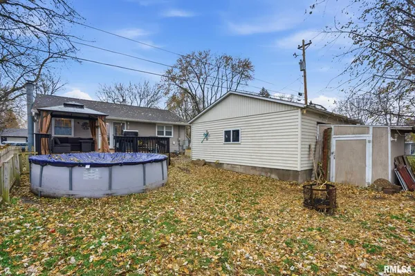 a view of a house with wooden fence