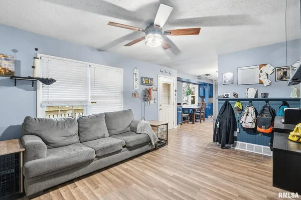 a living room with furniture and a wooden floor